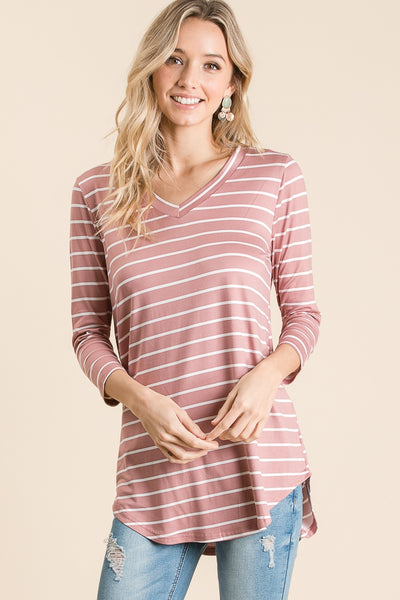 Untucked view of 3/4 sleeve tunic with v-neck in mauve with white stripes paired with jeans.