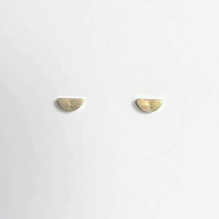 Tiny brass half moon stud earrings with sterling silver posts.