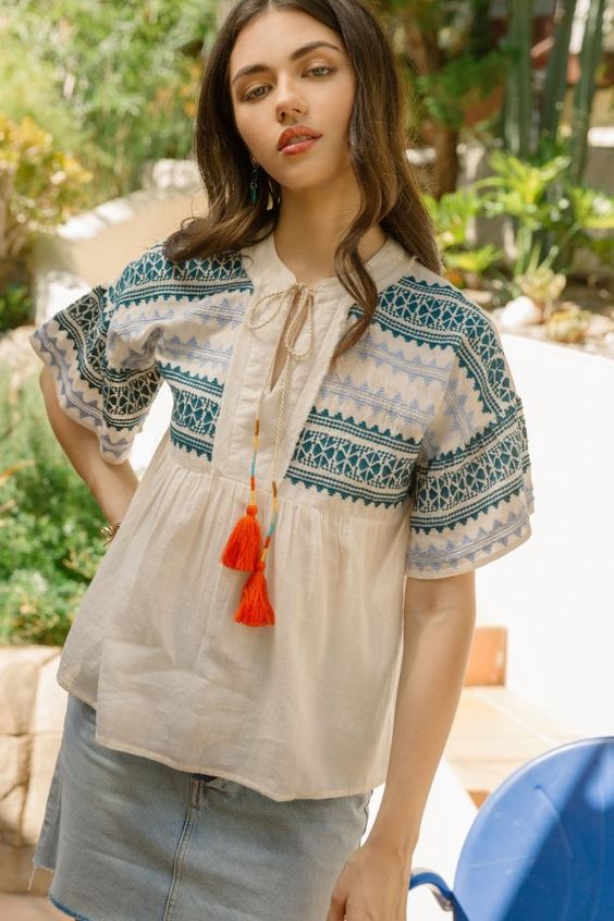 Blue and green embroidered shirt with colorful tassels and drop shoulder.