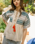 Blue and green embroidered shirt with colorful tassels and drop shoulder.