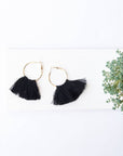 Black tassel hoop earrings in gold metal.