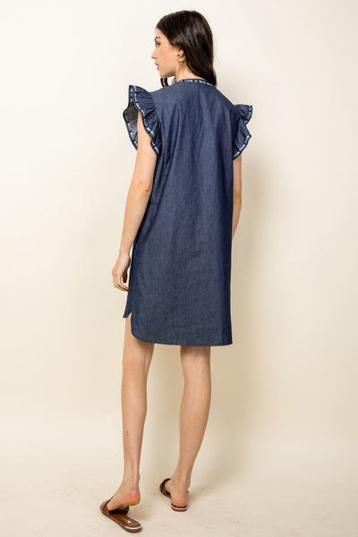 Back view of Woman's embroidered denim dress. Chambray with ruffle sleeves.