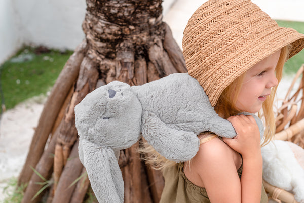 Girl playing with Cute stuffed animal bunny for Easter.