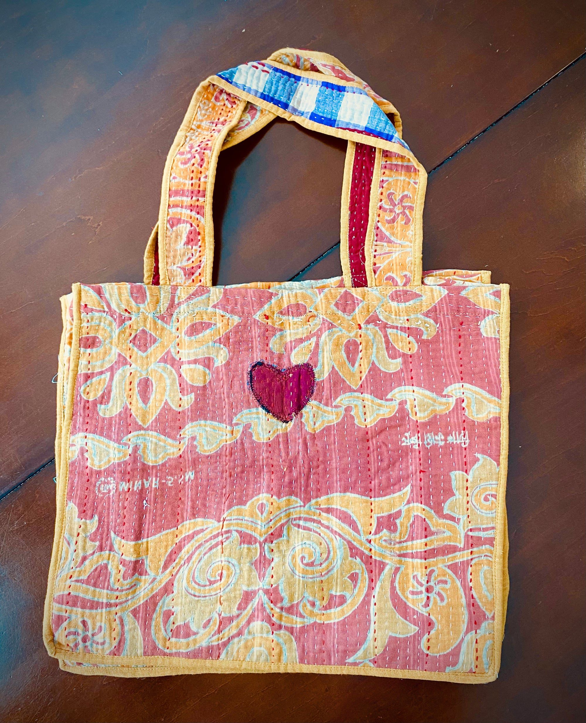 Kantha stitch bags. Orange floral on pink background.