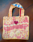 Kantha stitch bags. Orange floral on pink background.