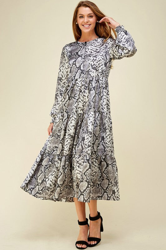 Women&#39;s dresses with long sleeves. Tiered maxi in snake skin print.