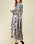 Side view of snake print dress with long sleeves and tiered maxi skirt.