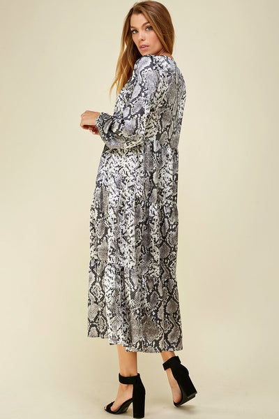 Side view of snake print dress with long sleeves and tiered maxi skirt.