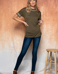 Full view of Cute embroidered tops for women. Olive with embroidered edge. Paired with jeans and booties.