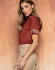 Side view of Cute embroidered tops for women. Rust with embroidered edge.