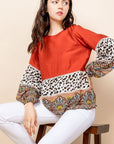 Long sleeved animal print and paisley blouse.