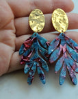 Bold statement earrings with gold and rich colorful acrylic leaves.