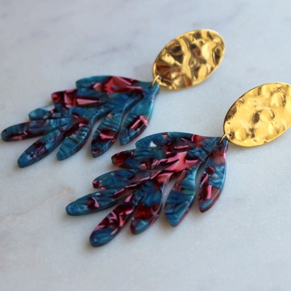 Gold statement earrings with acrylic leaves.