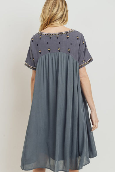 Back view of relaxed fit boho dress with embroidery at yoke and sleeves.