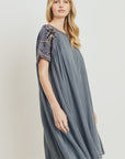 Side view of grey boho dress with pretty embroidery at sleeve and neckline. Knee length and relaxed fit.