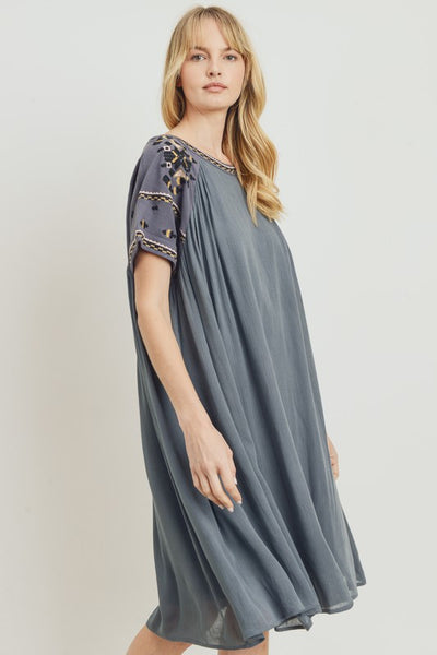 Side view of grey boho dress with pretty embroidery at sleeve and neckline. Knee length and relaxed fit.