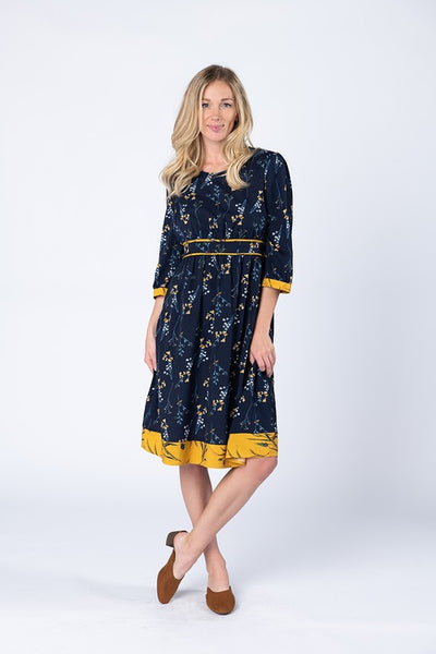 Women's dresses long sleeve. Navy with pretty yellow floral print and yellow trim at cuffs and hem. 