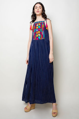 Blue maxi dress with colorful embroidered bodice and tassel straps.