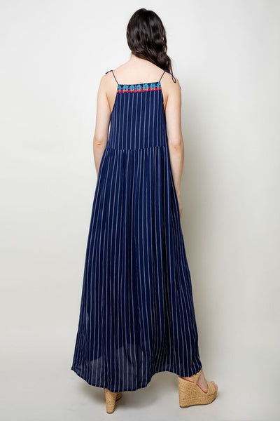 Back view of blue and white striped maxi with tassel straps.