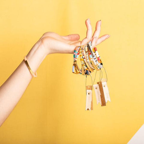 Miyuki bracelets with colorful glass beads.Bunch of miyuki bracelets held by model.