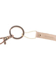 Leather hang tag used as keychain with message stamped on leather.