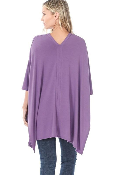 Back view of oversized lightweight poncho in different color to show long length and back v-neck.
