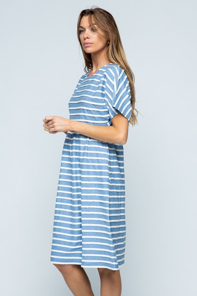 Side view of short sleeve cotton blue midi dress with white stripes.