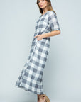 Buffalo check midi dress in grey and white with pockets paired with chunky heels.