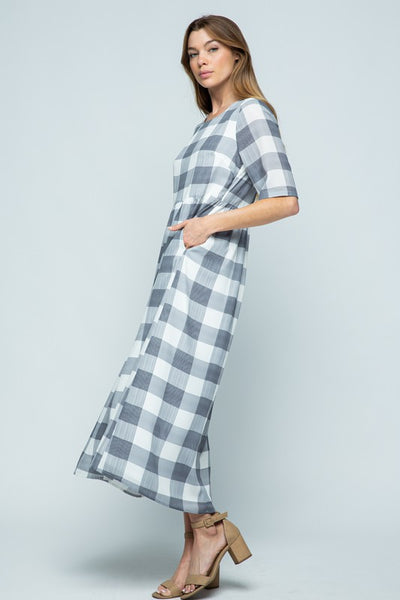 Buffalo check midi dress in grey and white with pockets paired with chunky heels.
