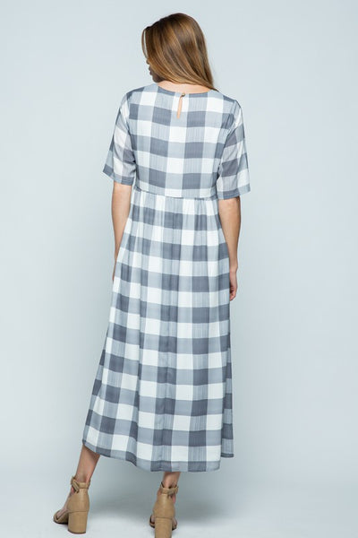 Back view of white and grey large check midi length dress with keyhole closure.