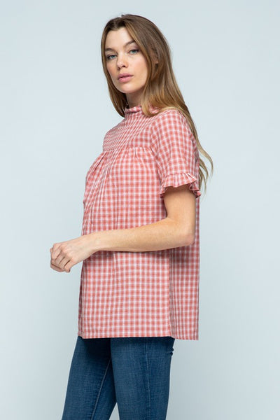 Side view of short ruffle sleeve top with cute orange/red plaid, mock neck, and good length for long torsos.