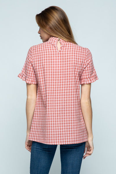 Back view of woman's plaid short ruffle sleeve top with button keyhole closure.