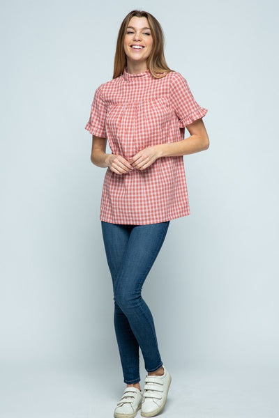 Cute mock neck plaid woman's top with ruffle short sleeve and good length paired with jeans and sneakers.