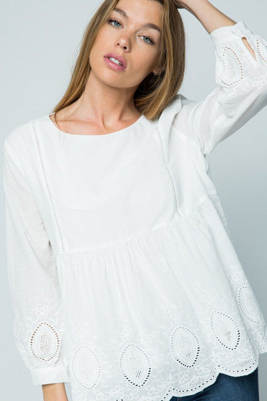 White boho top with embroidery and 3/4 sleeve.