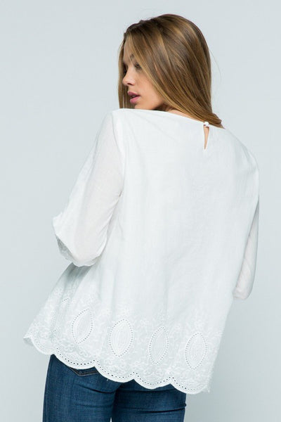 Back view of all white boho top with embroidery and keyhole closure.