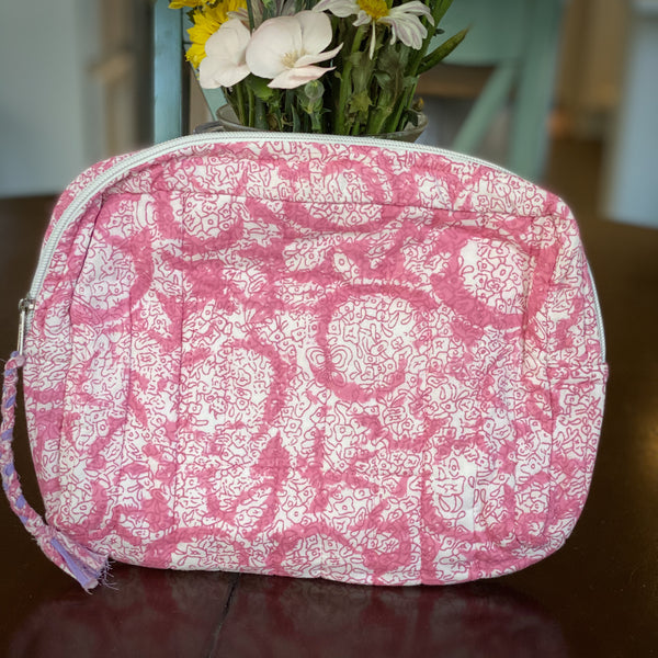 Cotton travel pouch in pink and white pattern.