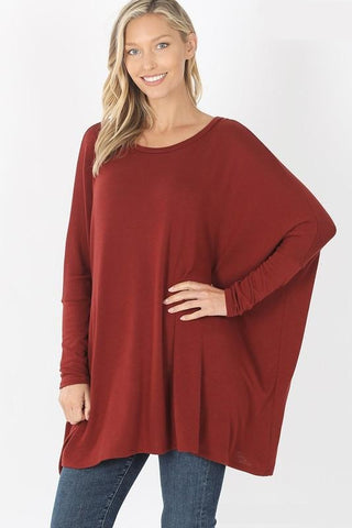 Women's poncho with sleeves in fired brick. Round neck and oversized long sleeve fit.