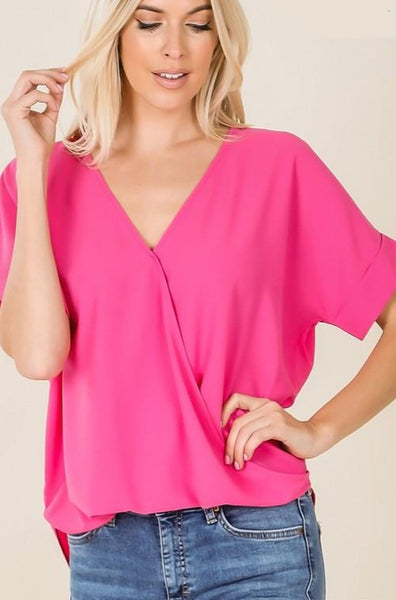 Women's wrap drape front blouse with rolled short sleeves and v-neck in hot pink color.