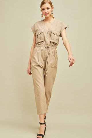 Women's jumpsuit with sleeves in khaki cargo cut with drawstring waist, cap sleeves, and button front. Straight leg.