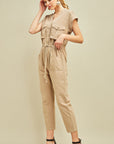 Khaki cargo button front drawstring waist jumpsuit with cap sleeves.