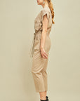 Side view of women's cargo jumpsuit in khaki with straight leg, check and side pockets, and drawstring waist.