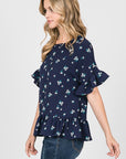 Side view of short ruffle sleeve peplum top in navy floral print.