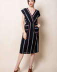 Black v-neck midi patio dress with colorful vertical stripes.