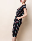 Side view of v-neck striped patio dress with large square pockets and elastic waist.