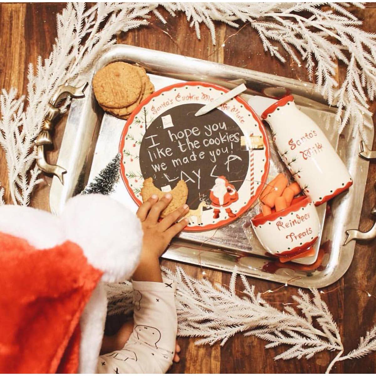 Image of Christmas Decor for Home with Children - Santa&#39;s Message Plate Set in use with child&#39;s message written on chalkboard finished plate, milk pitcher, and reindeer treat bowl.