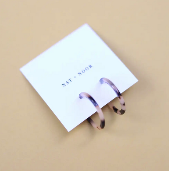Image of small hoop earrings on display card in tortoise color.