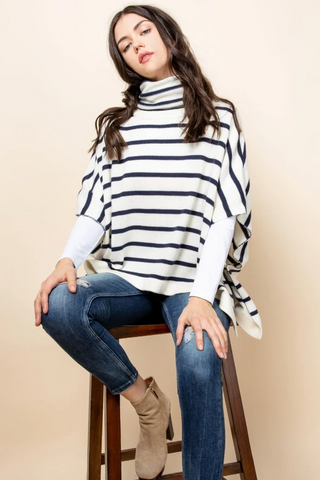 Striped turtleneck sweater poncho for women. Ivory with navy horizontal stripes.