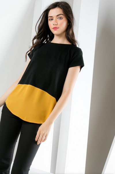Women's black short sleeve knit top with gold poly contrast hem.
