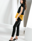 Side view of women's short sleeve black and gold contrast hem top with rounded hemline.