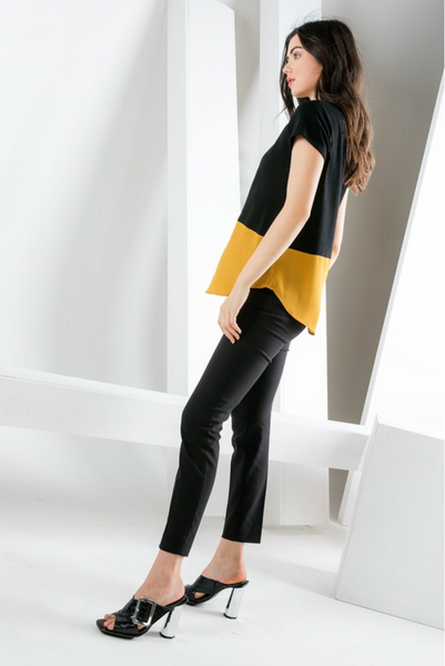Side view of women's short sleeve black and gold contrast hem top with rounded hemline.